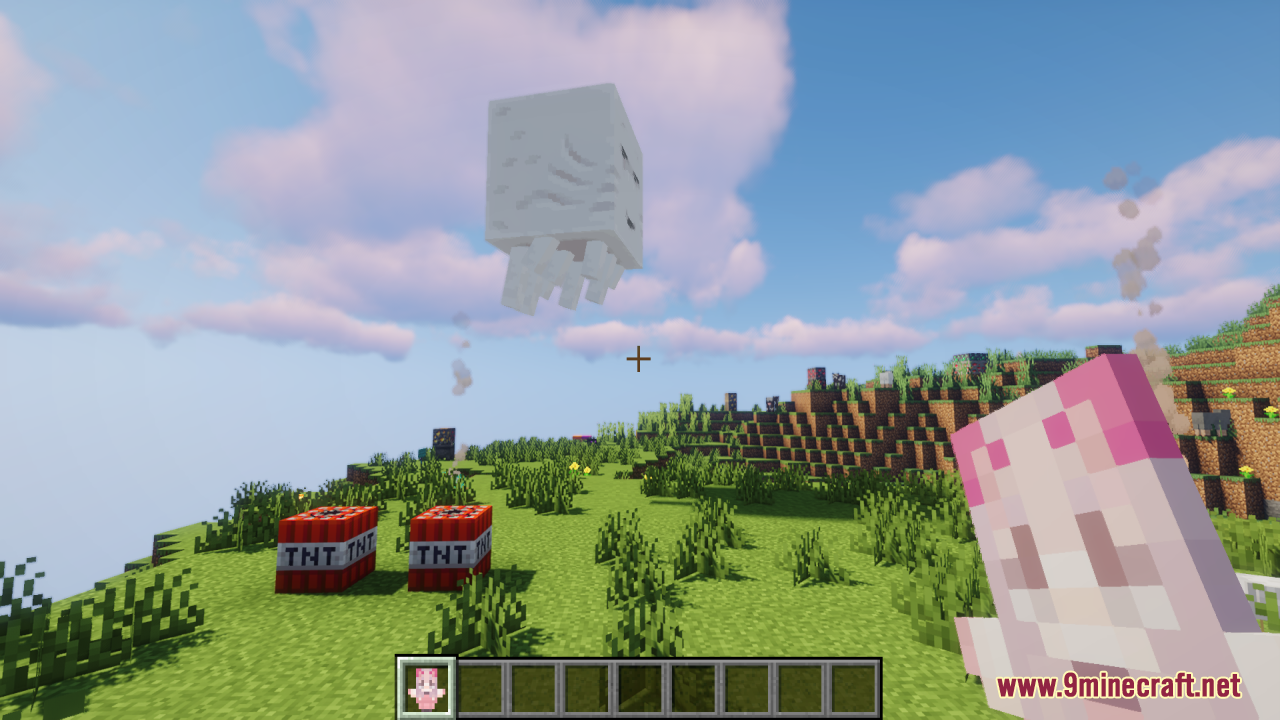 Player holding a pink totem near TNT while a Ghast floats above