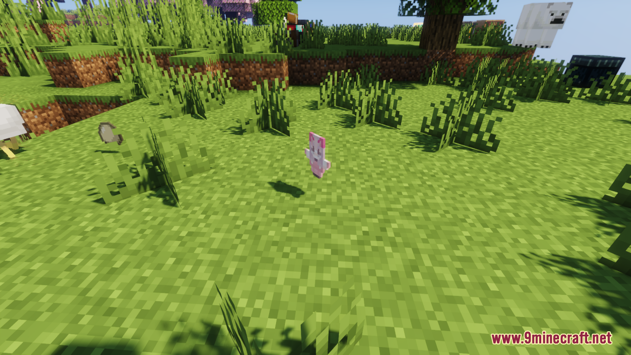 A cute pink character totem item floating on the grass in a sunny field
