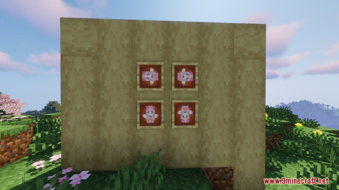 Four pink totems of undying displayed in item frames on a wall