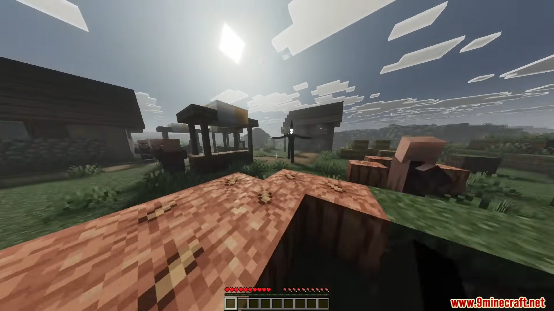 Playmate Addon Screenshot 4 A tall dark entity with a white face standing in a village