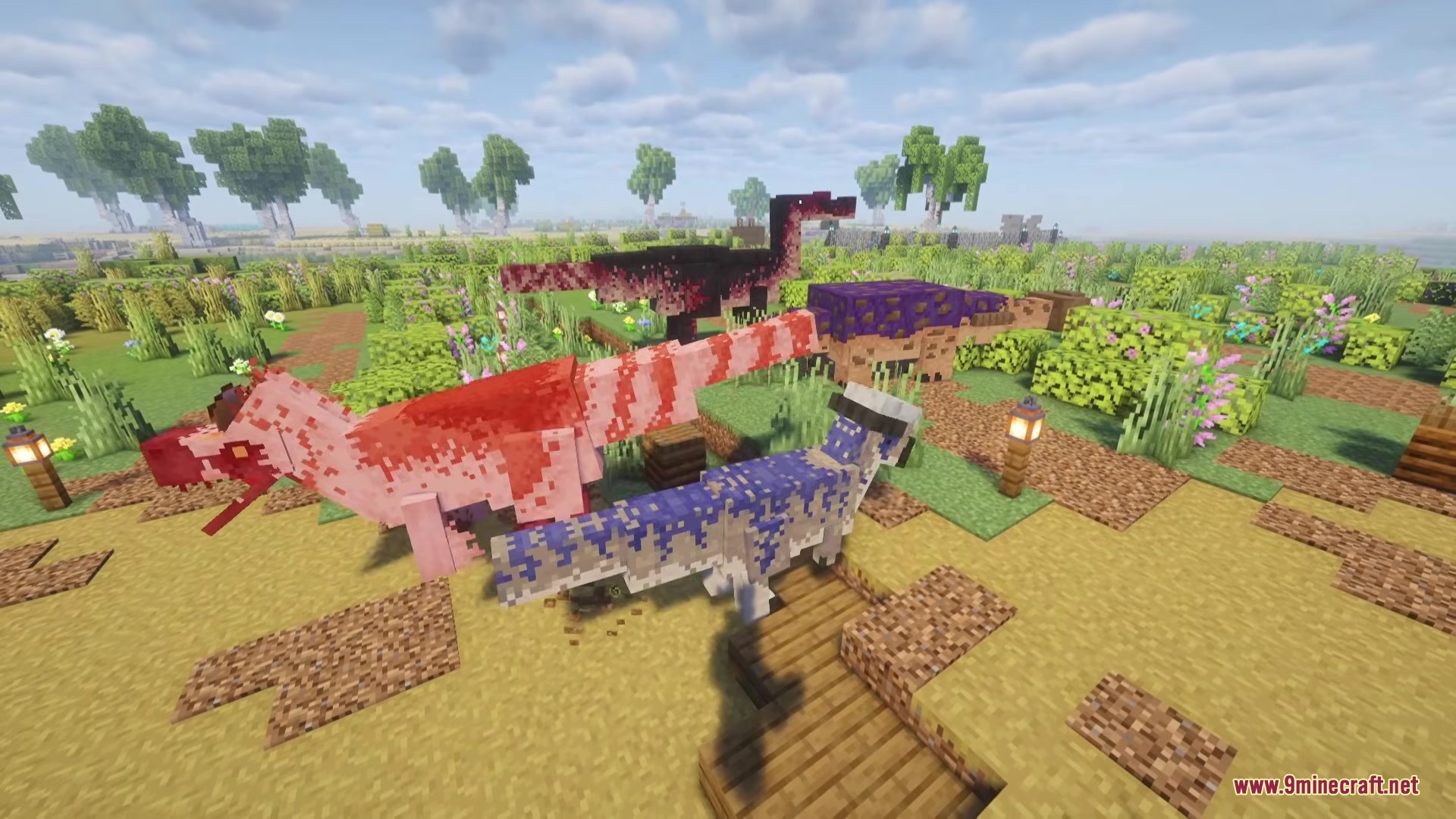 Several colorful dinosaurs stand in a grassy field with lanterns and trees