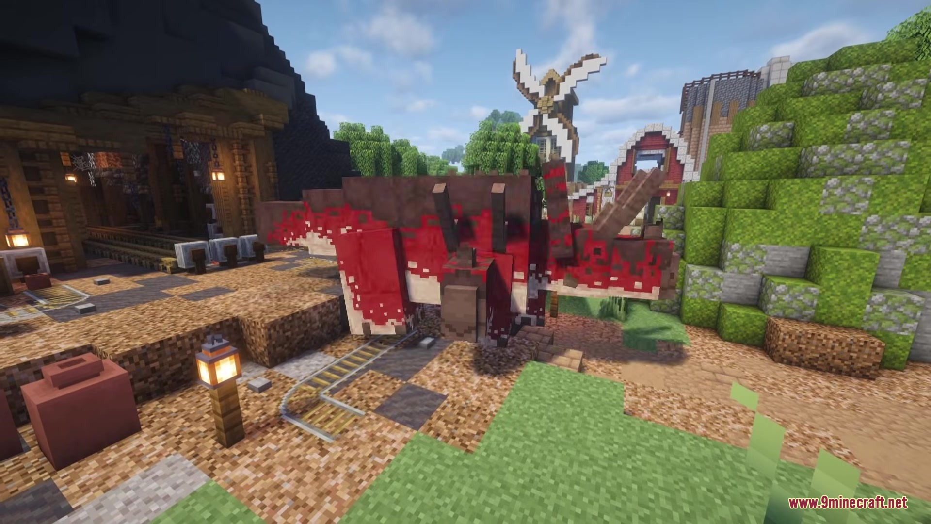 A red and white Triceratops standing on a path near a windmill