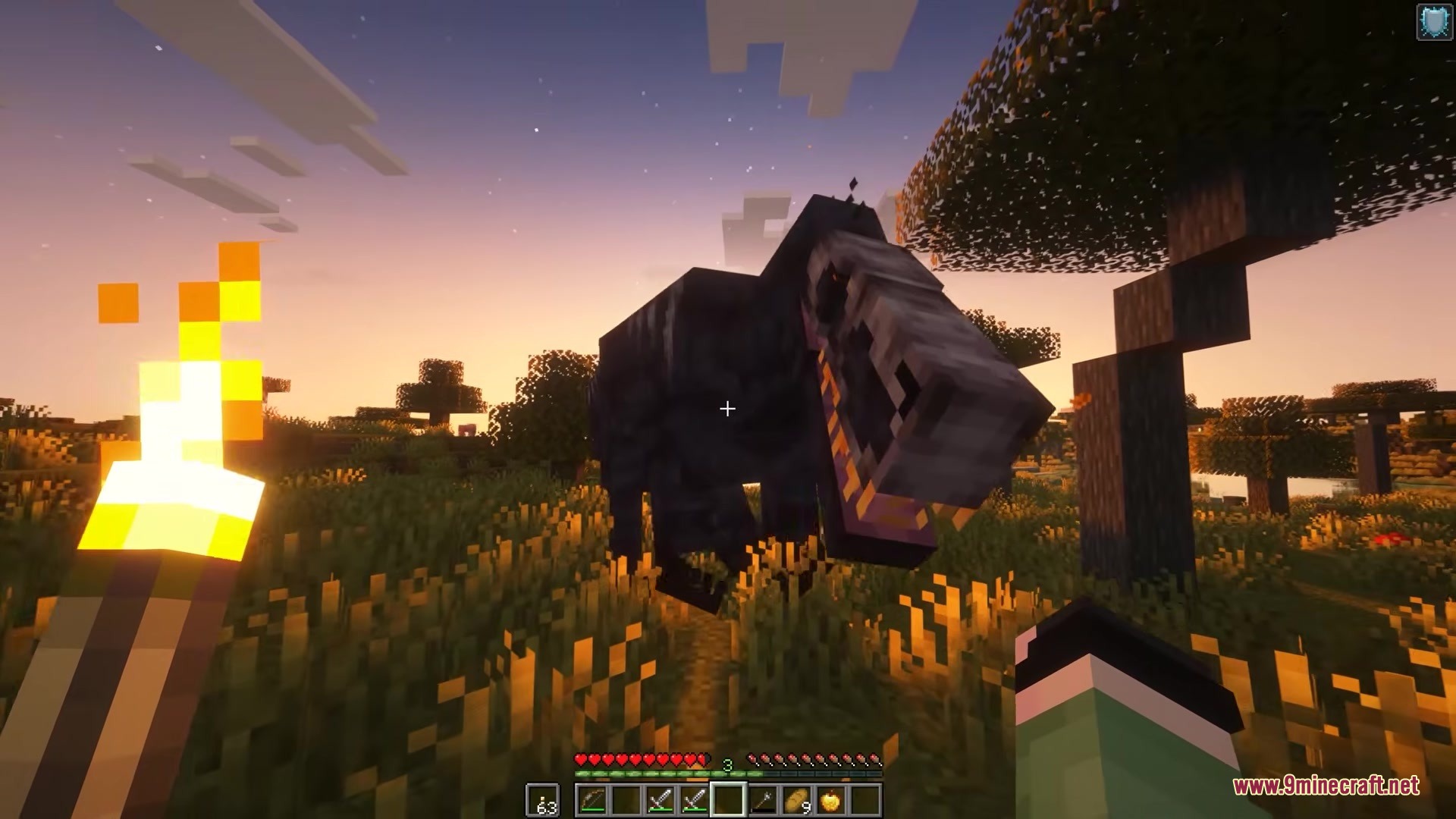 Primal Frontier Mod Screenshot 5 Player holding a torch encounters a large dinosaur in the savanna