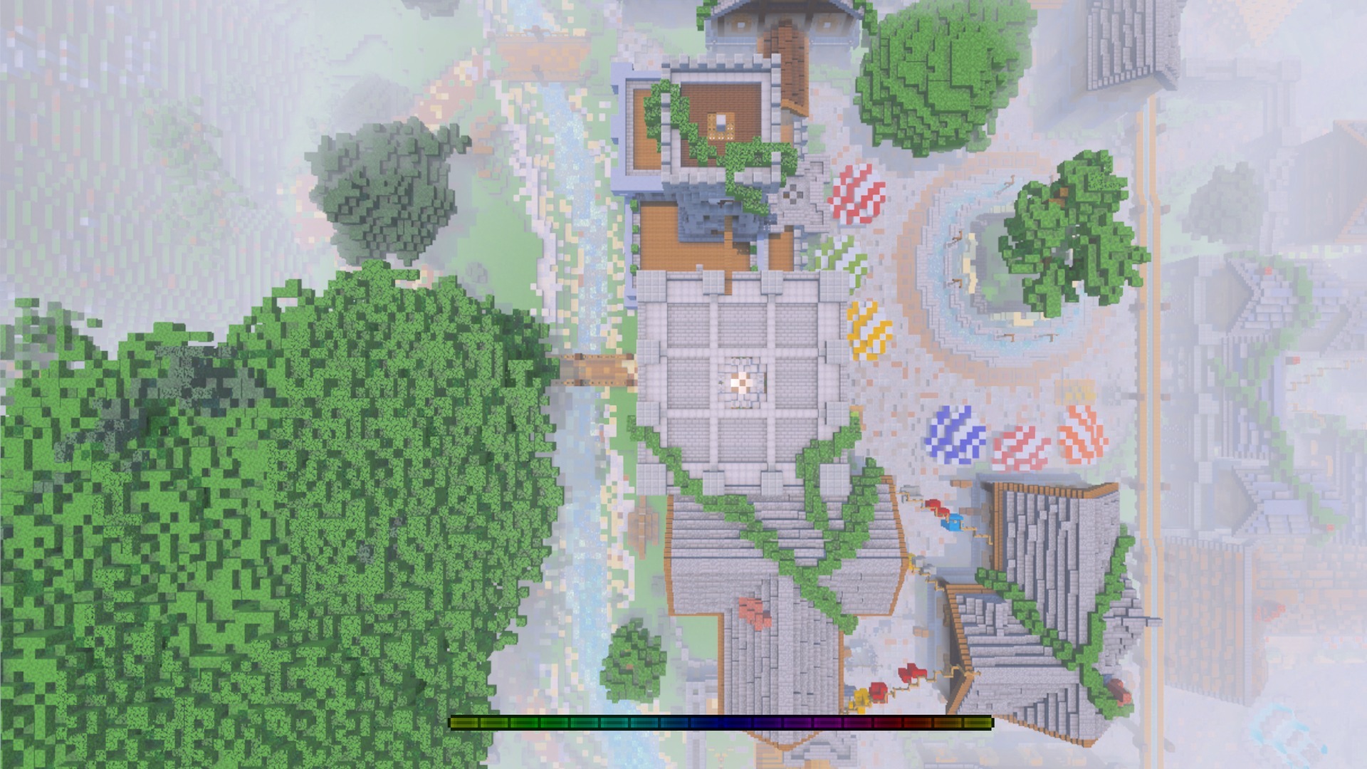 Aerial view of a village showing the rainbow colored experience bar at bottom