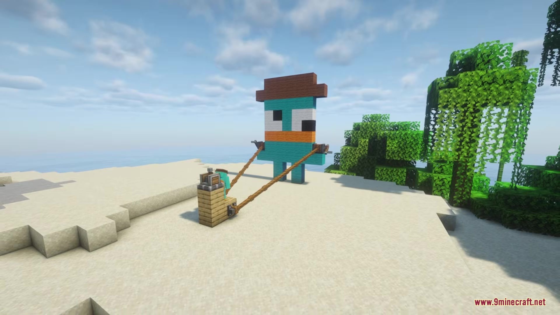A giant Perry the Platypus build holding leads on a sandy beach