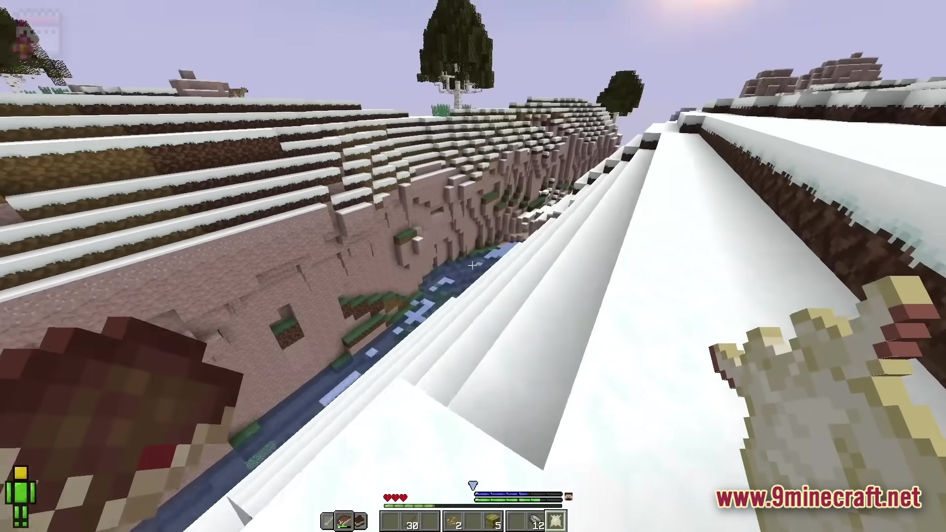 Realistic Craft Modpack Screenshot 1 A first-person perspective of a snowy canyon landscape with a river flowing through the center
