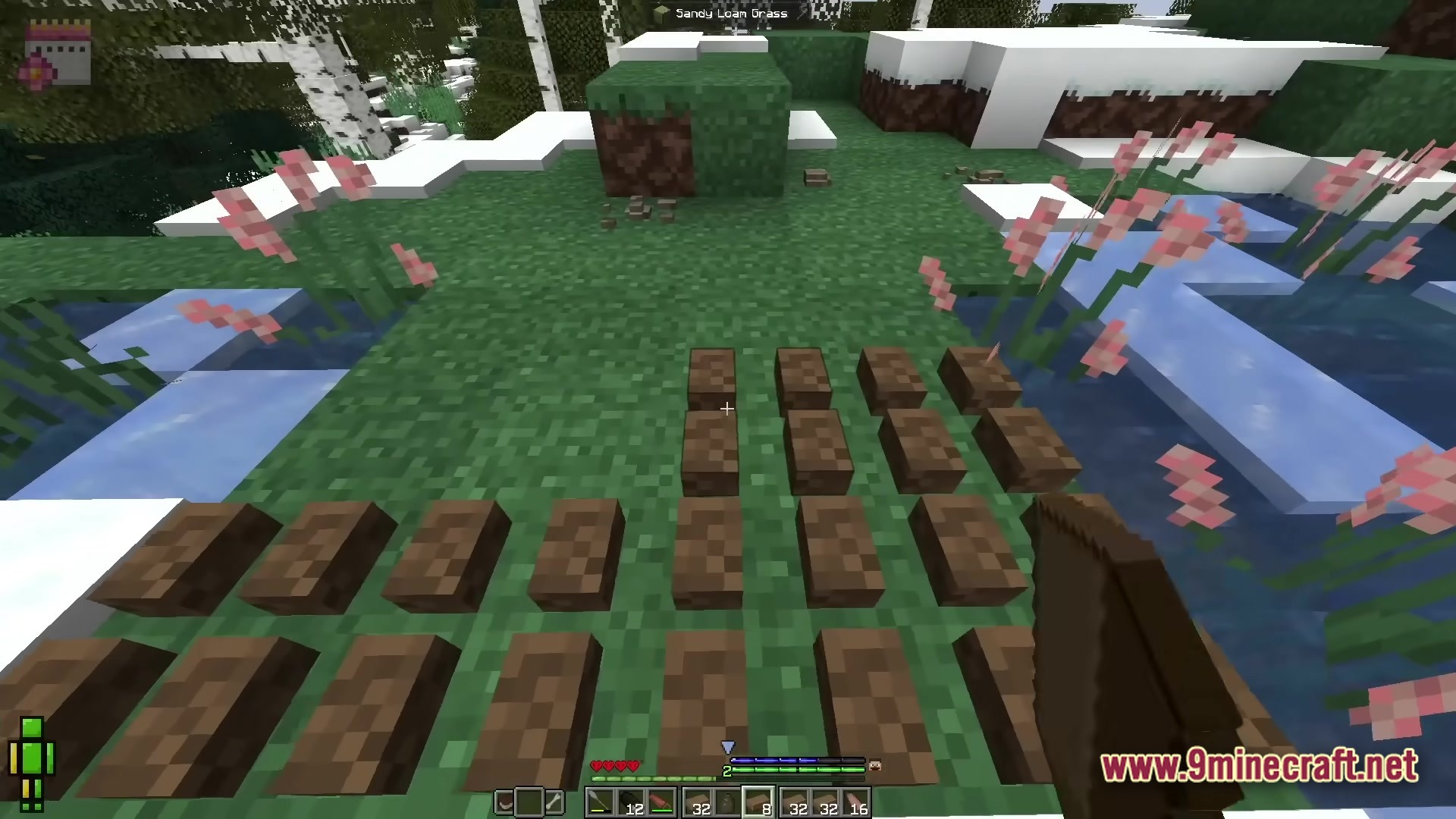 Realistic Craft Modpack Screenshot 4 A player places wet clay bricks on grass to dry in a snowy birch forest biome