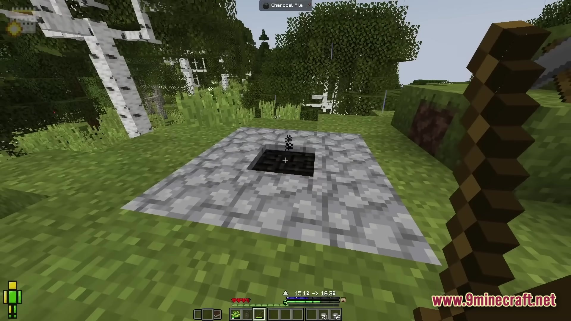 Realistic Craft Modpack Screenshot 5 A charcoal pile structure surrounded by cobblestone blocks in a grassy birch forest biome