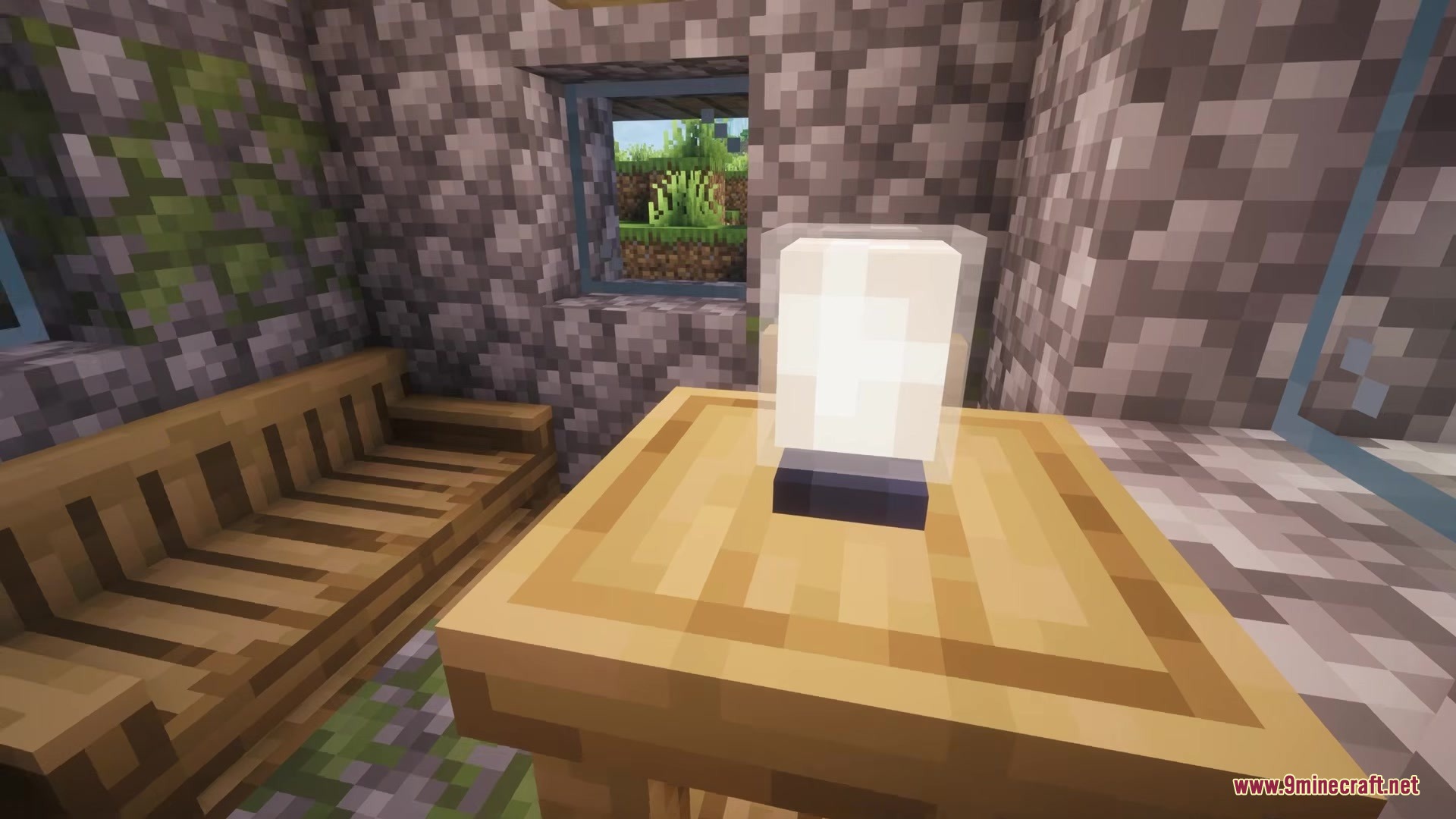 A white lamp sits on a wooden table inside a cozy cobblestone room