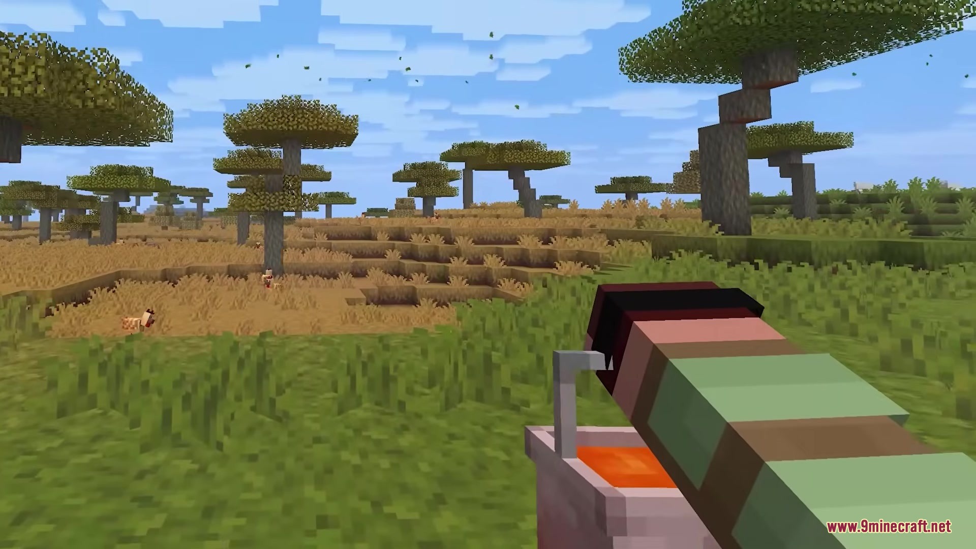 A player holding a chunky 3D bucket of lava in a savanna