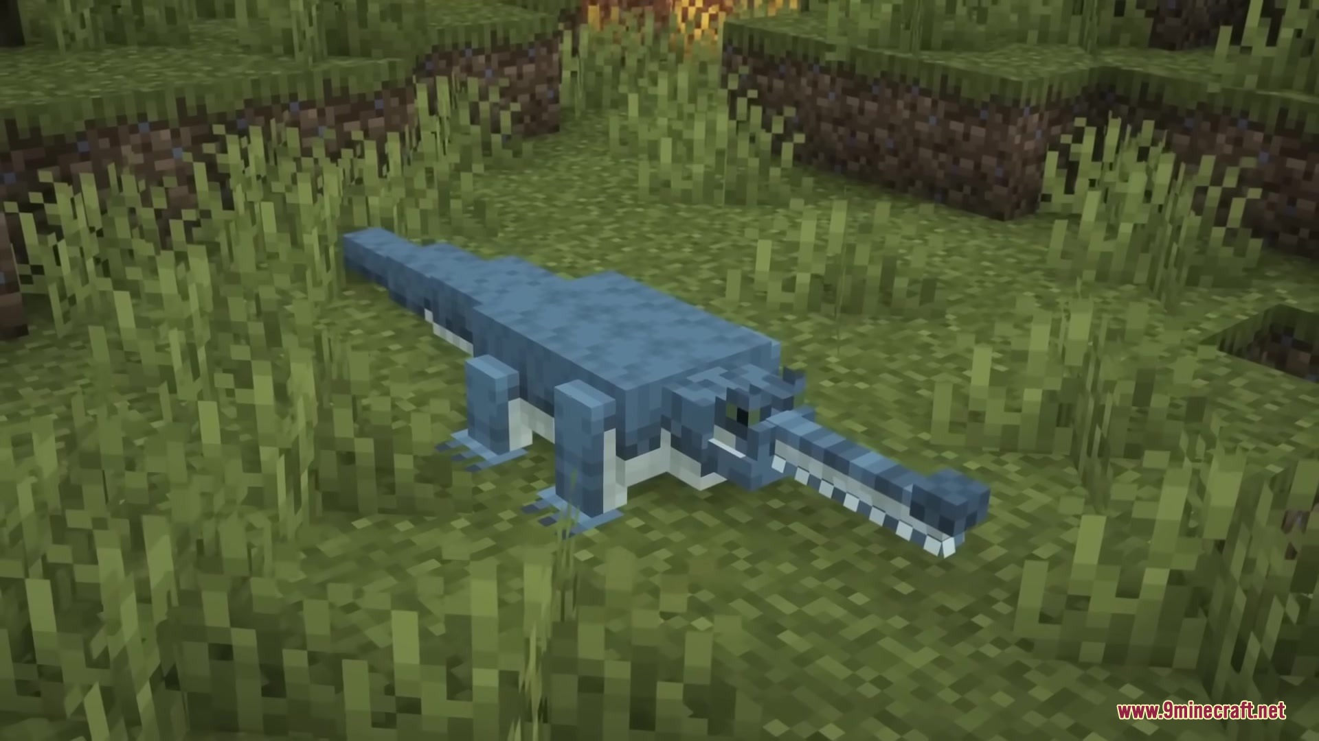 Reptilian Mod Screenshot 3 A long snouted gharial reptile stands in a grassy field in Minecraft