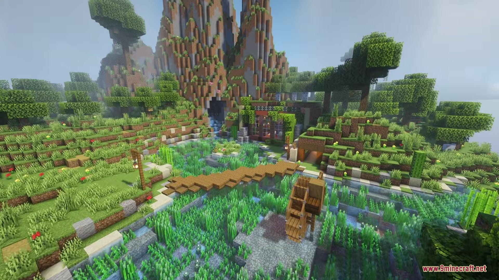 Reverse Eon Mod Screenshot 2 Beautiful Minecraft landscape featuring a mountain cave and a wooden bridge over water
