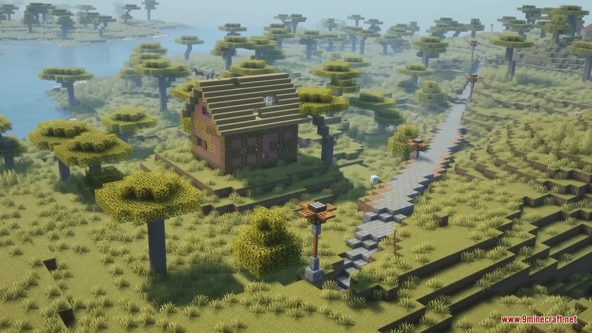 Road Weaver Mod Screenshot 11 A long stone road stretches across a savanna biome near a brick house