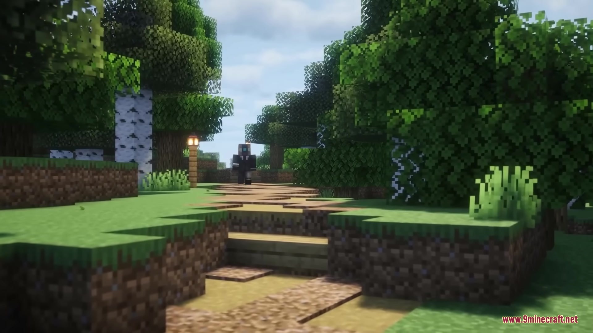 A player walks along a winding dirt path through a dense green forest