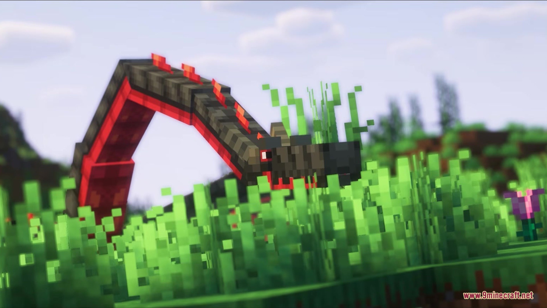 Saint's Dragons Mod Screenshot 2 A long red and black dragon peeks through tall green grass in Minecraft