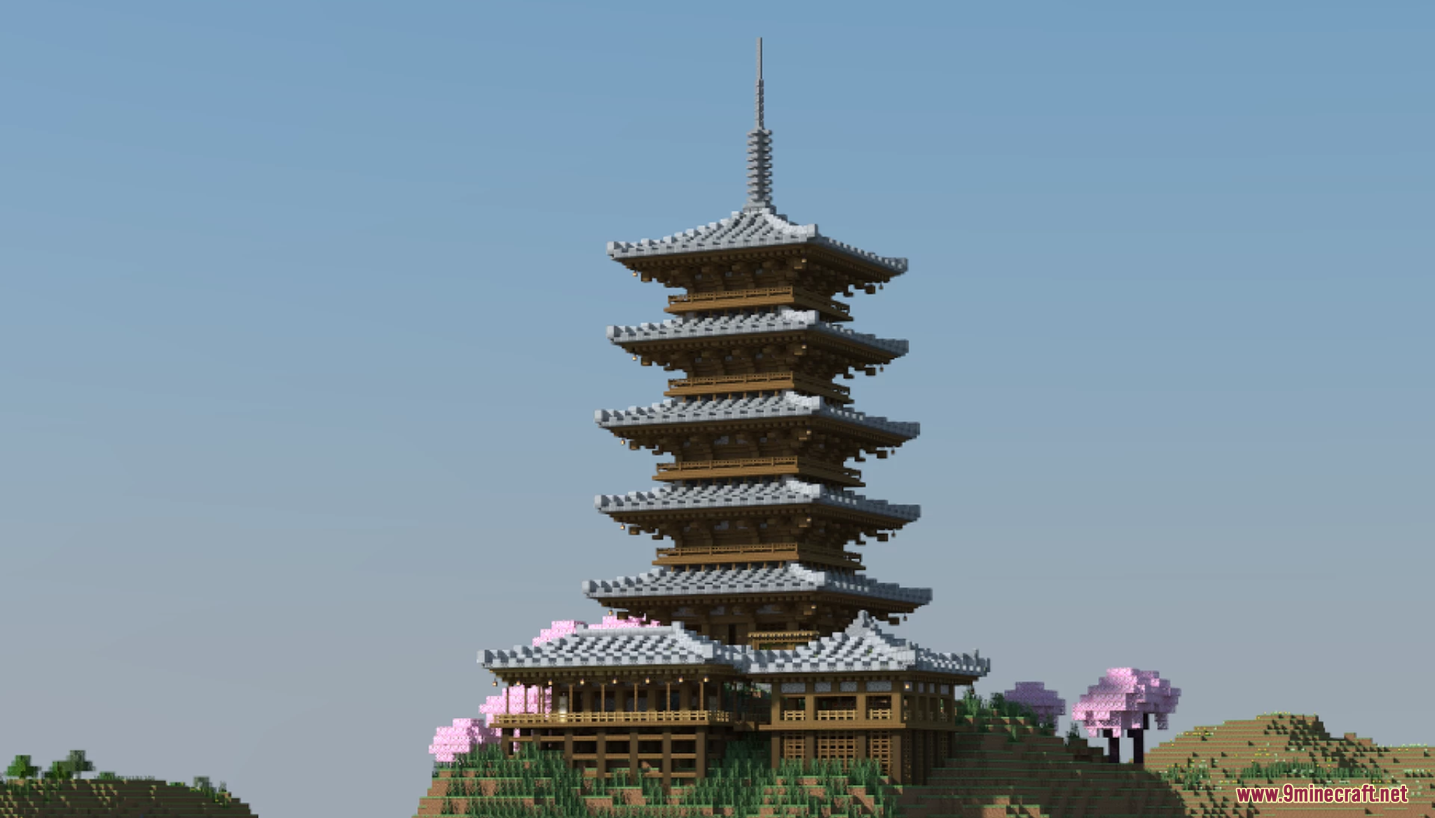 A tall multi tiered Sakura Pagoda built on a grassy hill in Minecraft