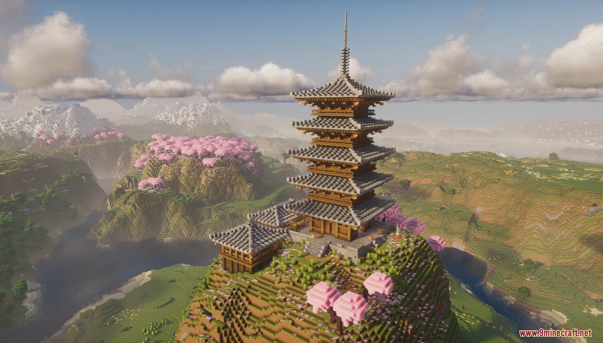 A tall Sakura Pagoda stands on a hill surrounded by pink cherry blossoms