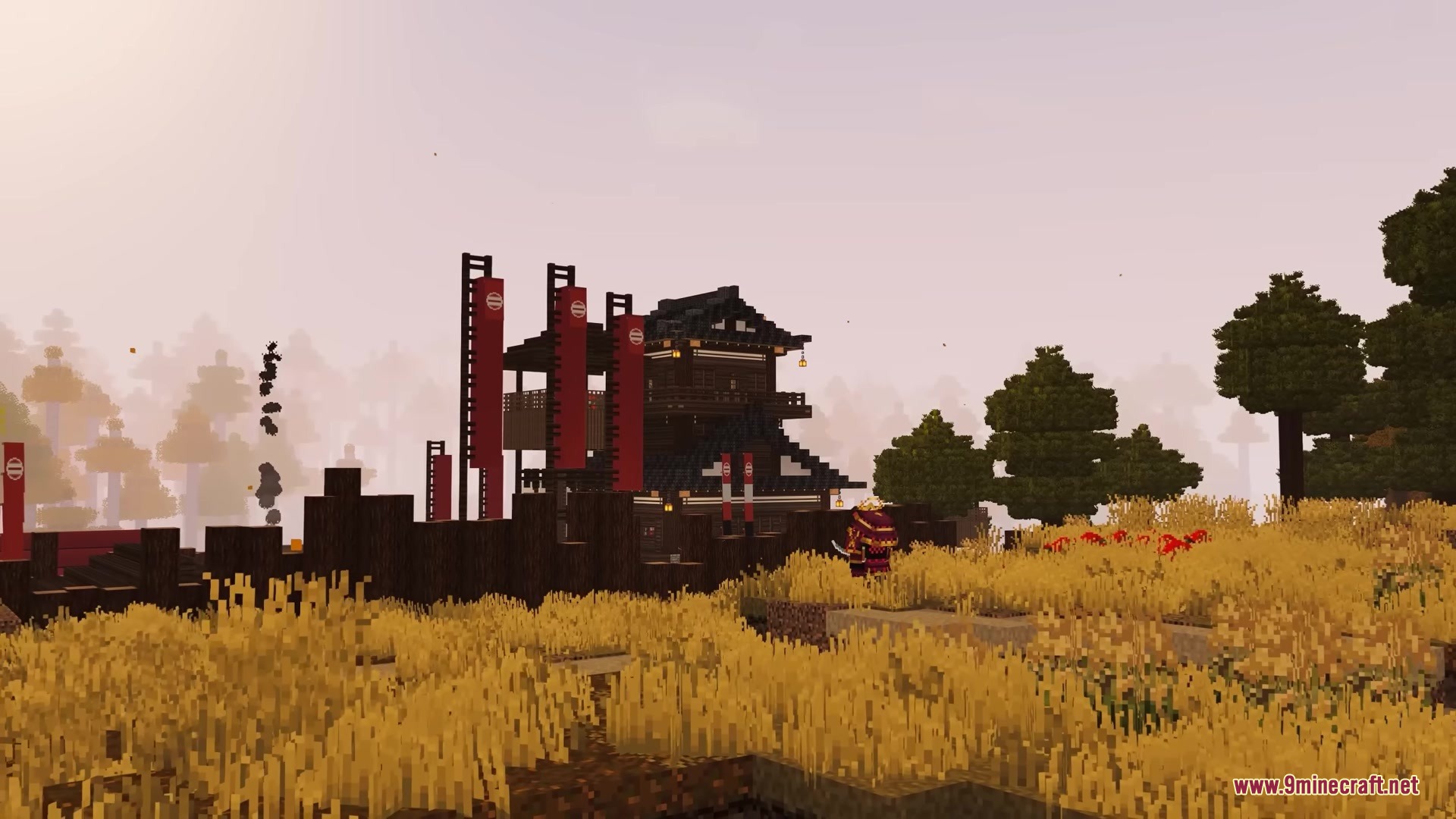 A traditional Japanese castle with red banners stands in a golden autumn field