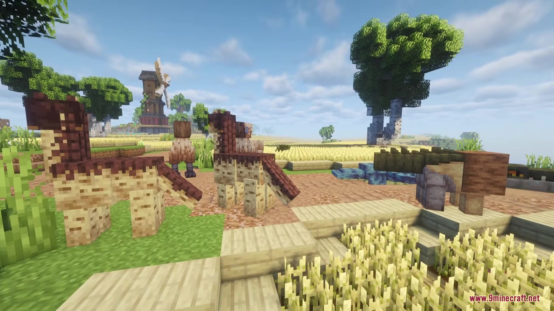 Shinea L's Prehistoric Expansion Mod Screenshot 3 Small spotted dinosaurs and a large predator standing near a farm windmill