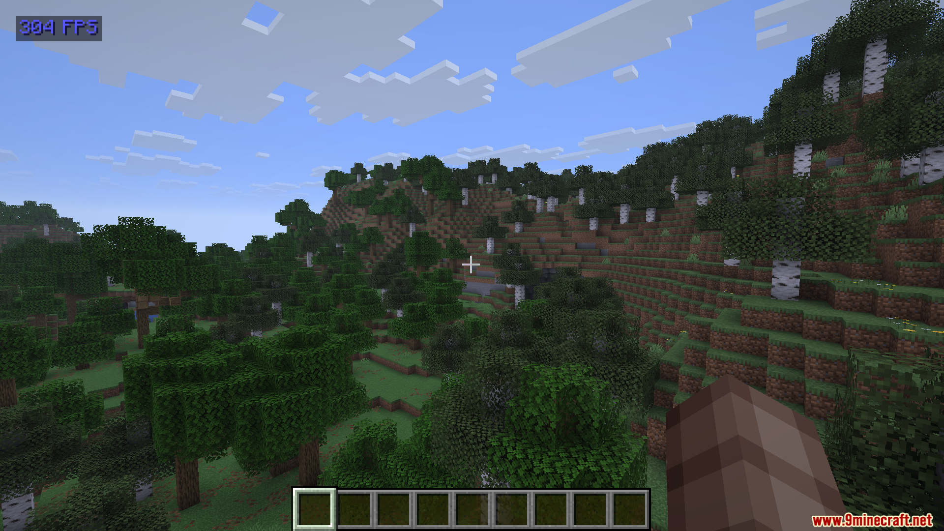 Show FPS Mod Screenshot 3 Blue frame rate counter displayed over a hilly Minecraft forest biome