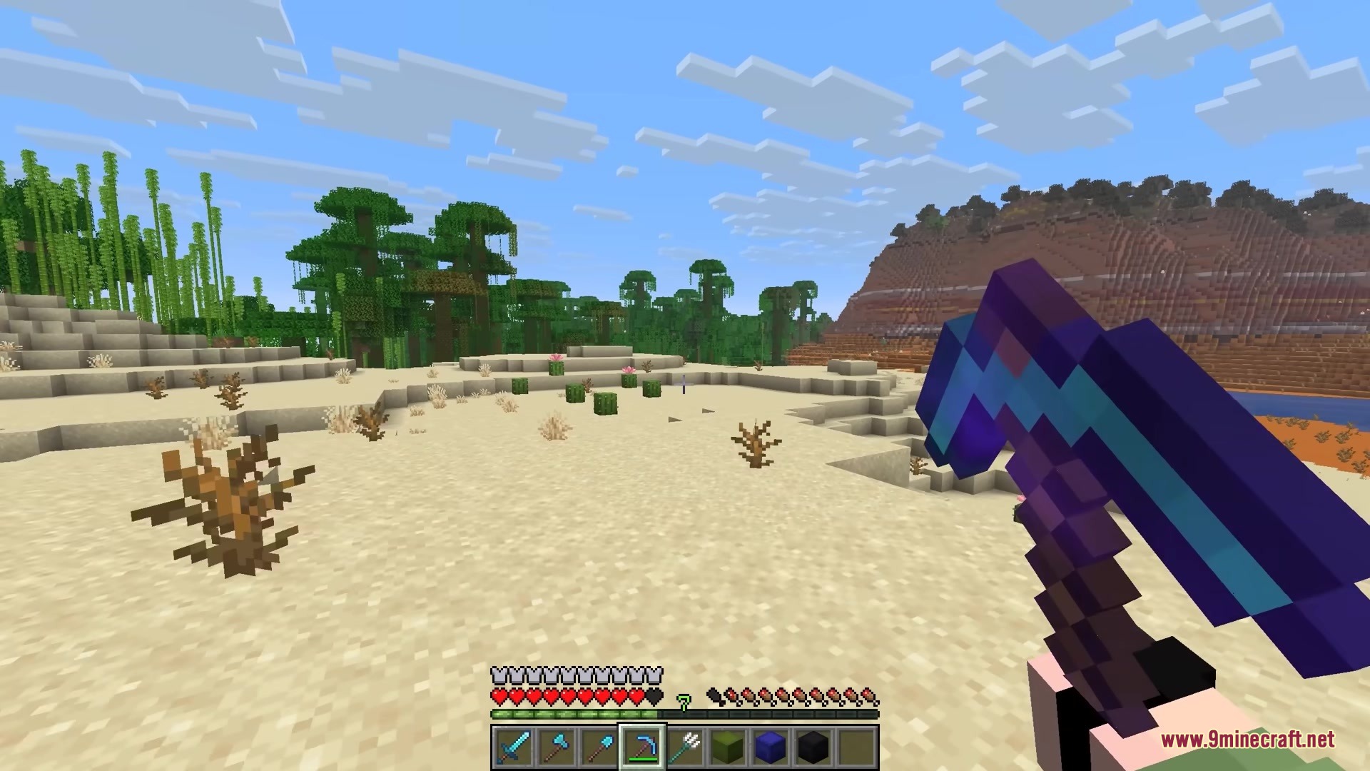 Shulker Peek Mod Screenshot 1 Player holding an enchanted pickaxe while standing in a sunny desert biome