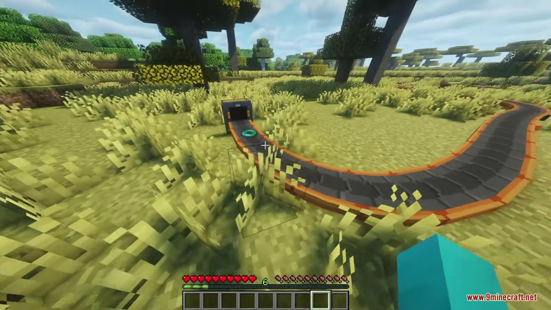 Simple Conveyor Belts Mod Screenshot 2 A green item travels along a winding conveyor belt through a sunny landscape
