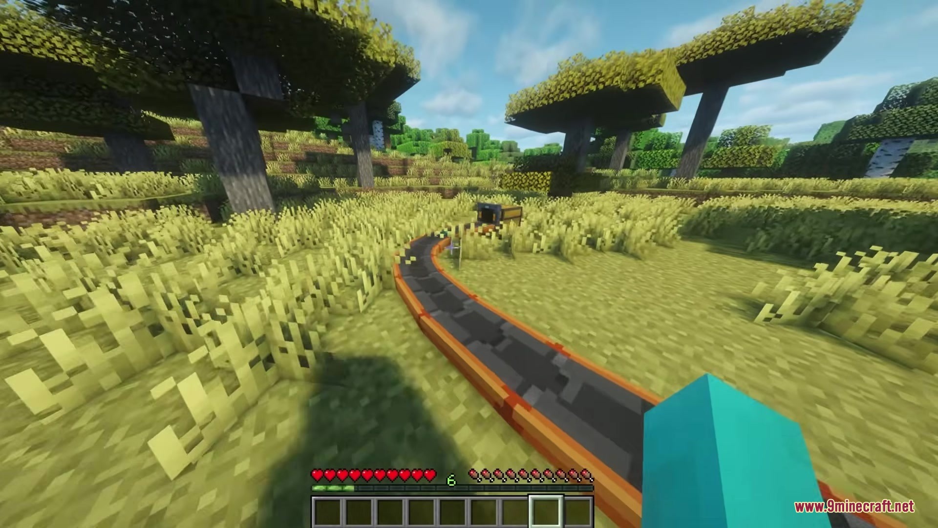 Simple Conveyor Belts Mod Screenshot 3 A curved conveyor belt transporting items across a grassy field to a chest