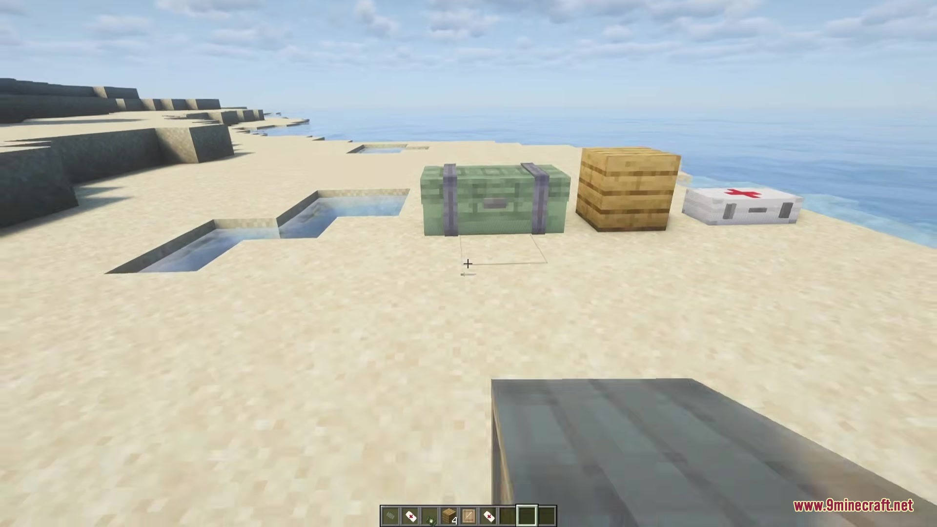 Simply Airdrops Mod Screenshot 3 Three different supply crates from Simply Airdrops Mod sitting on a beach