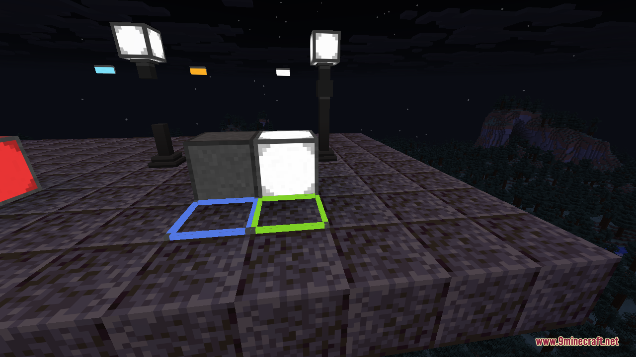 A close-up of a bright white illuminant block beside a plain switched-off block, with blue and green edge lights framing the floor tiles and rod lamps glowing around them at night