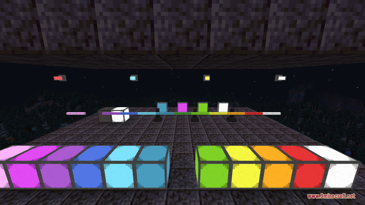 A long rainbow row of glowing illuminant blocks in many colours, from magenta, purple, blue, and cyan on one side to lime, yellow, orange, red, and white on the other, with thin edge lights running along their tops and small lamps floating in the dark background