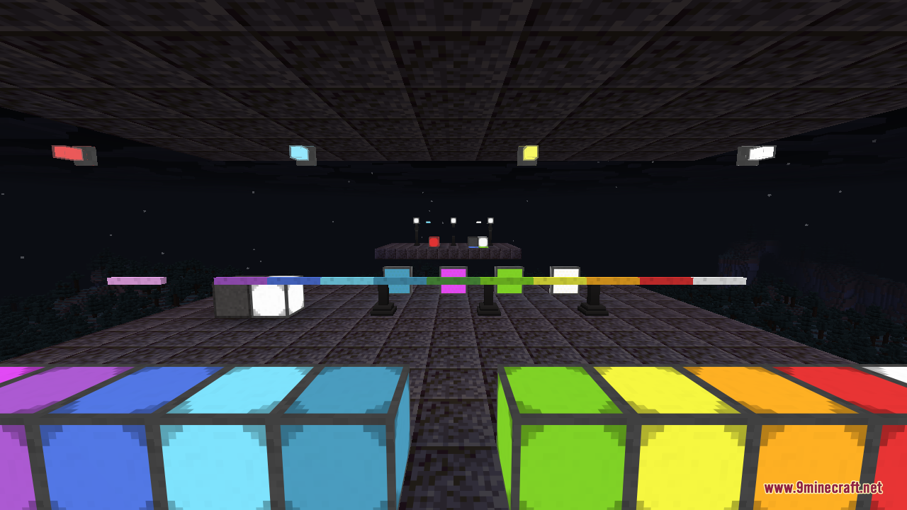 A wide view of many rainbow-coloured illuminant blocks arranged in rows with edge-light strips running across the floor and small wall lights glowing on the dark ceiling