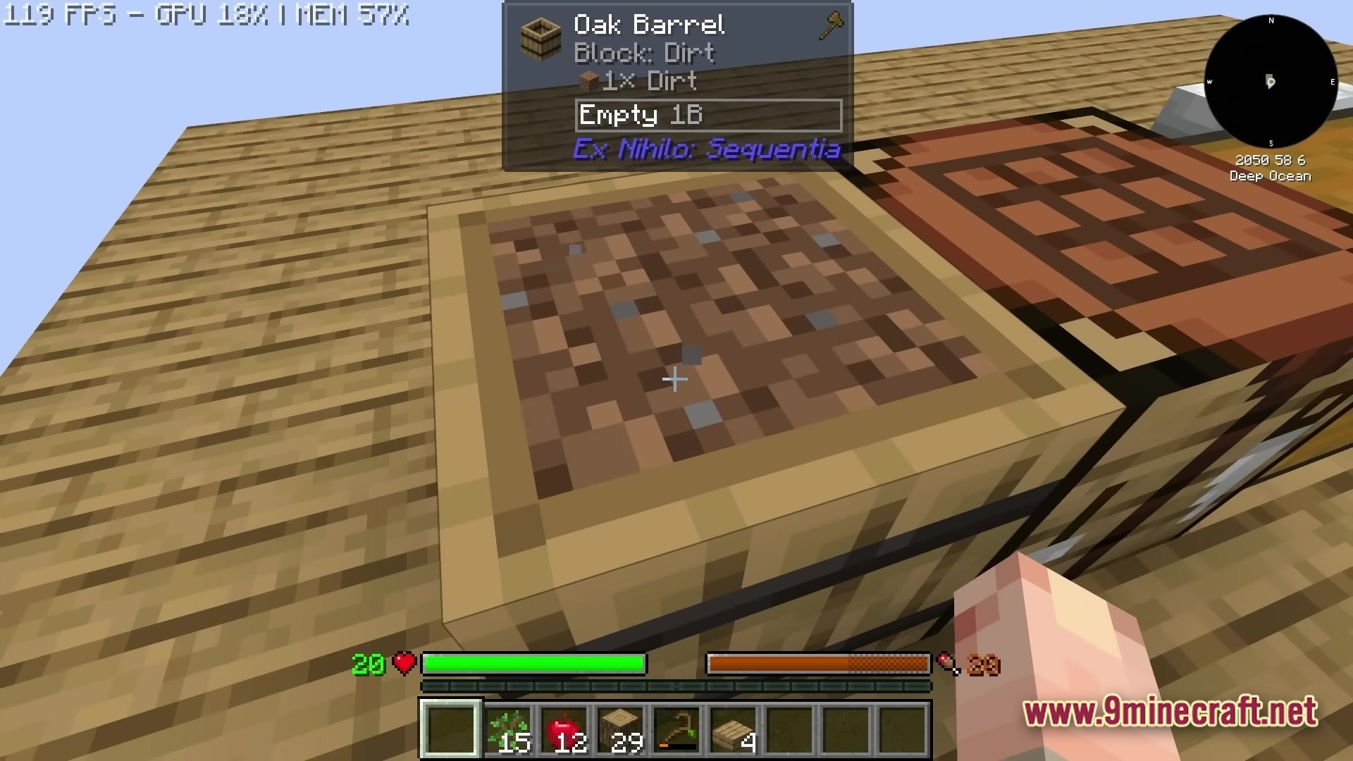 An Oak Barrel containing dirt sits on a wooden platform next to a crafting table