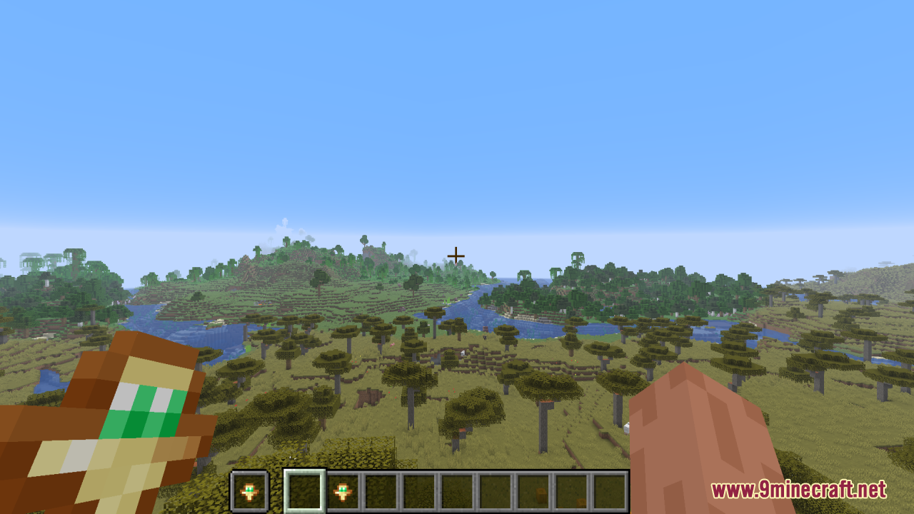 Smaller Totems Resource Pack Screenshot 6 A player holds a small totem of undying while overlooking a savanna