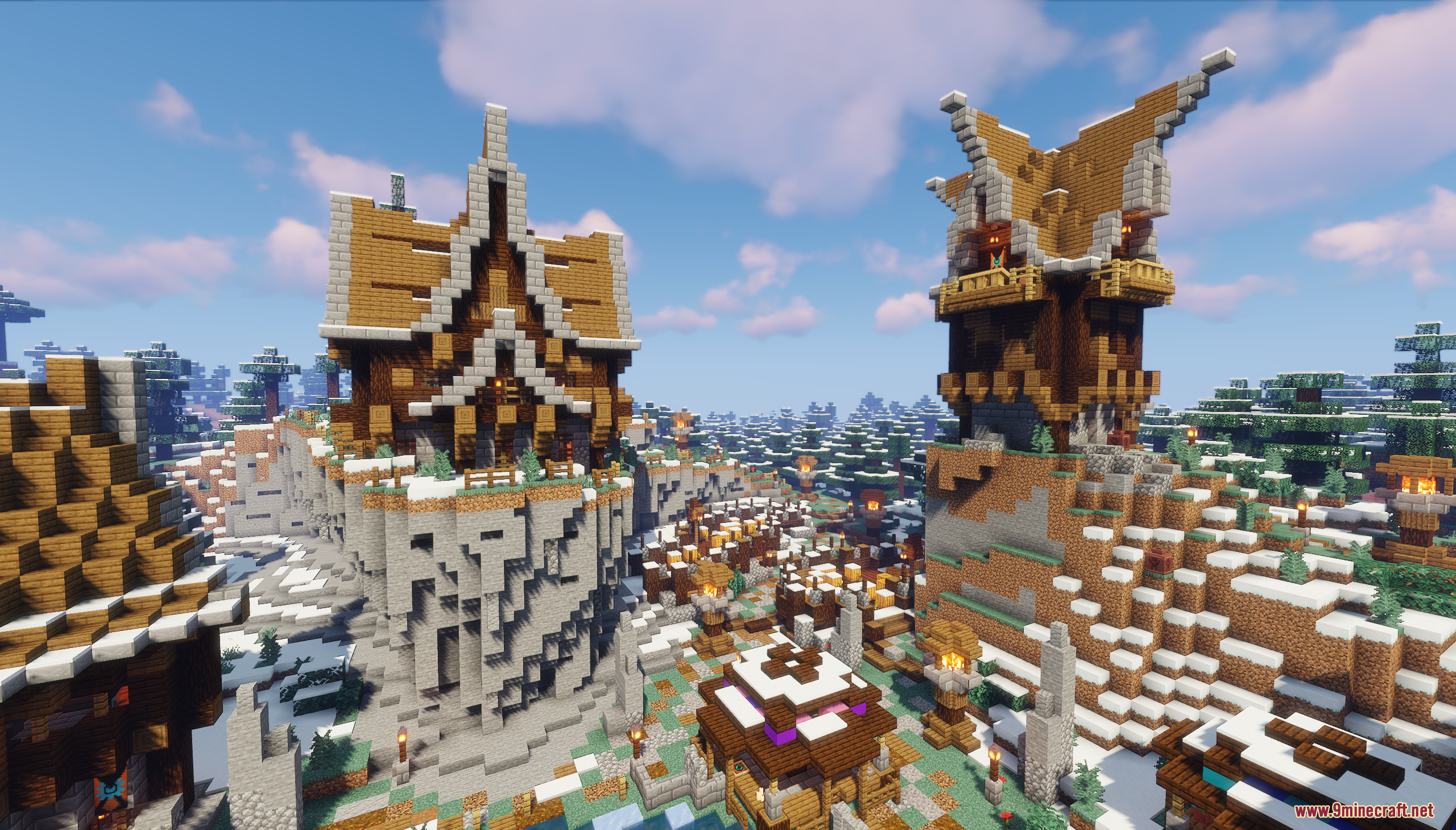 Large wooden buildings and a tall watchtower overlooking a snowy forest village