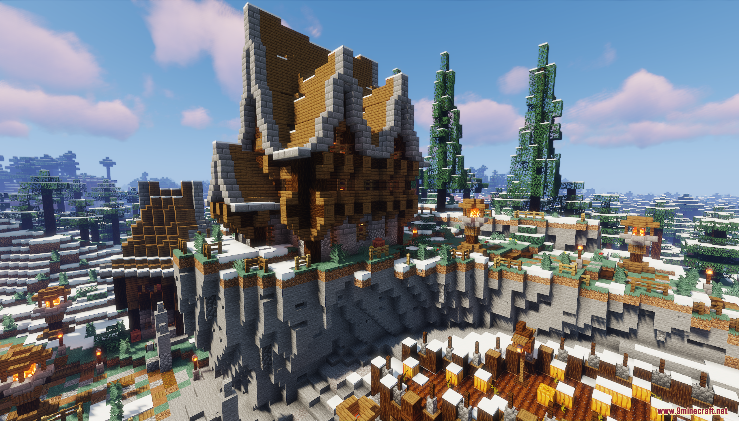 A large wooden house built on a snowy cliffside in a winter forest