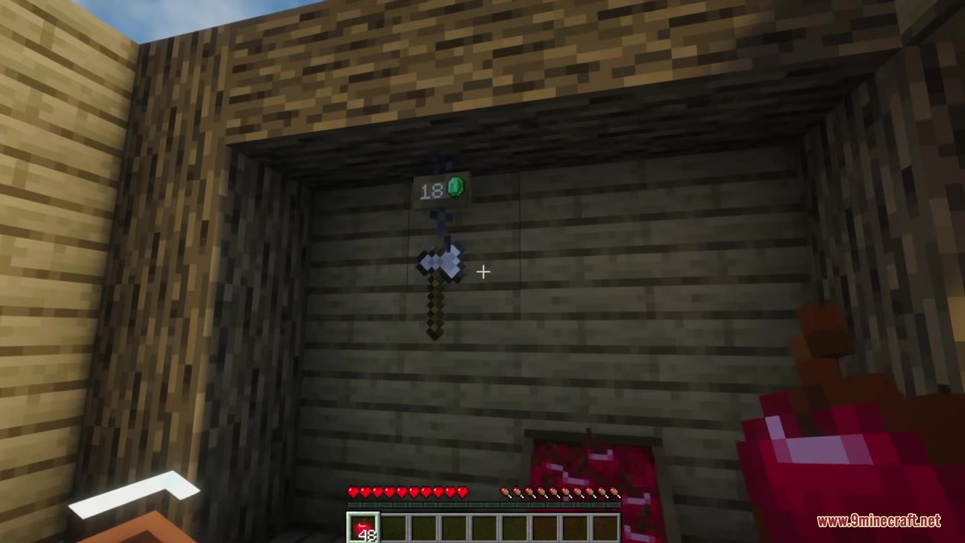 Spud's Shops Mod Screenshot 1 Iron axe hanging from a chain hook with an emerald price tag