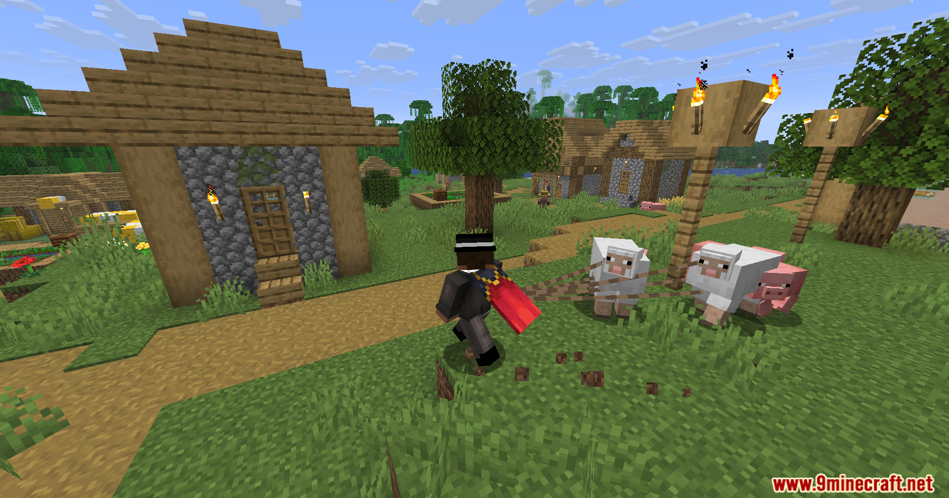 Strong Leads Mod Screenshot 2 Minecraft character pulling several farm animals with leads across a grassy village path