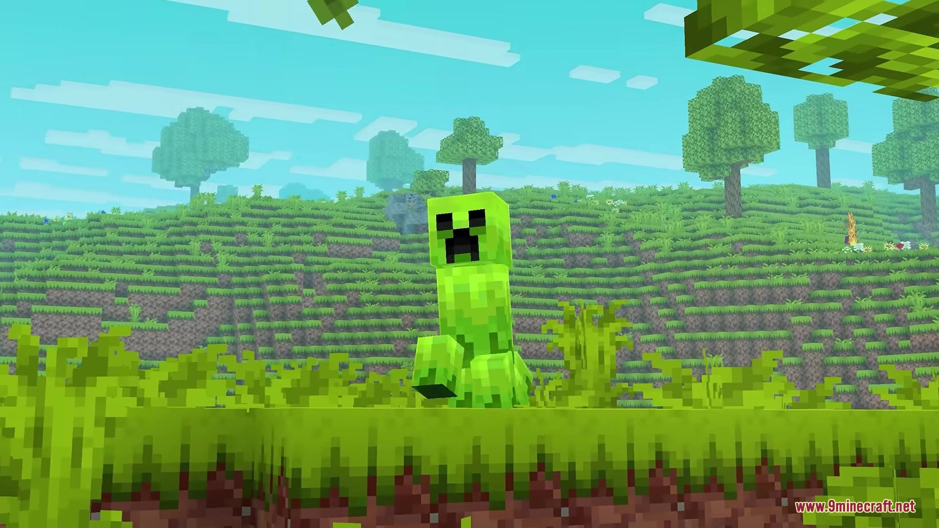 A bright green Creeper standing in a vibrant grassy field under a blue sky
