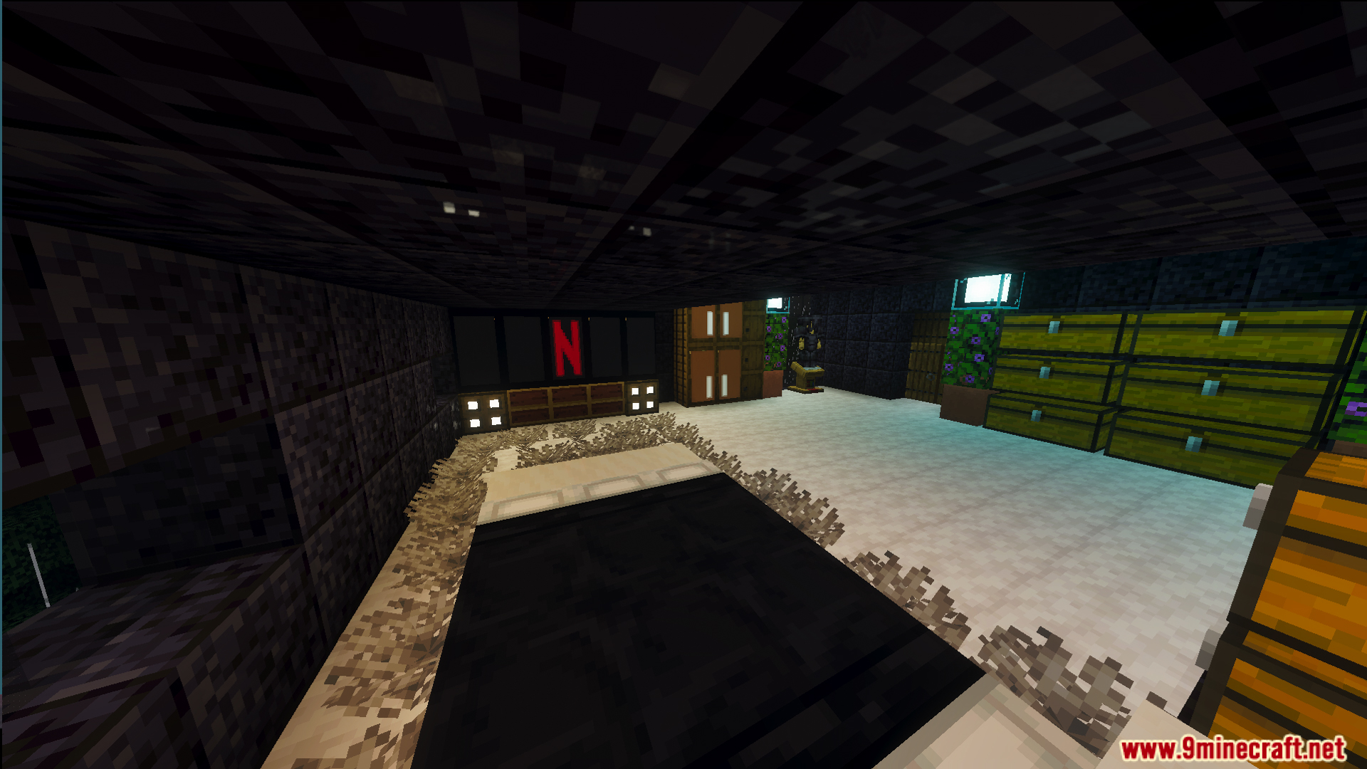 Modern interior of the survival house showing a bed and large television
