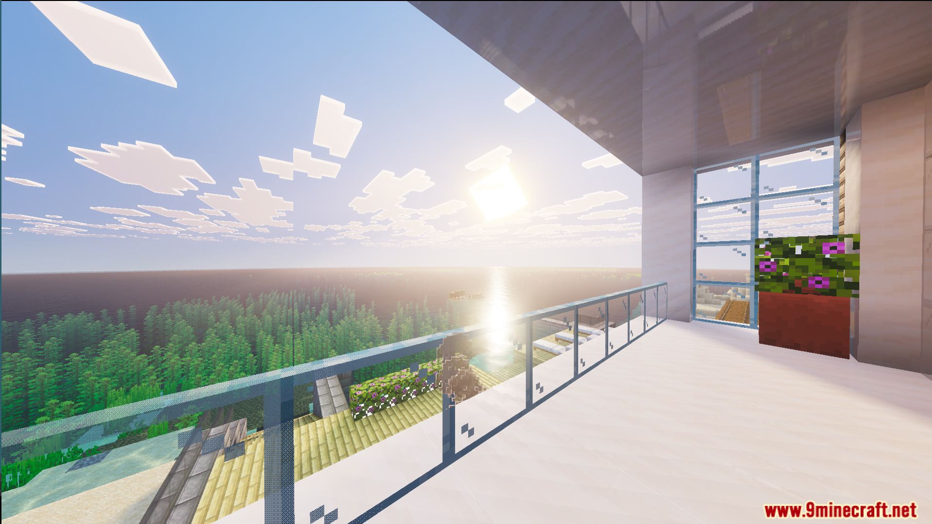 Outdoor patio of the modern house overlooking a lush forest and bright sun