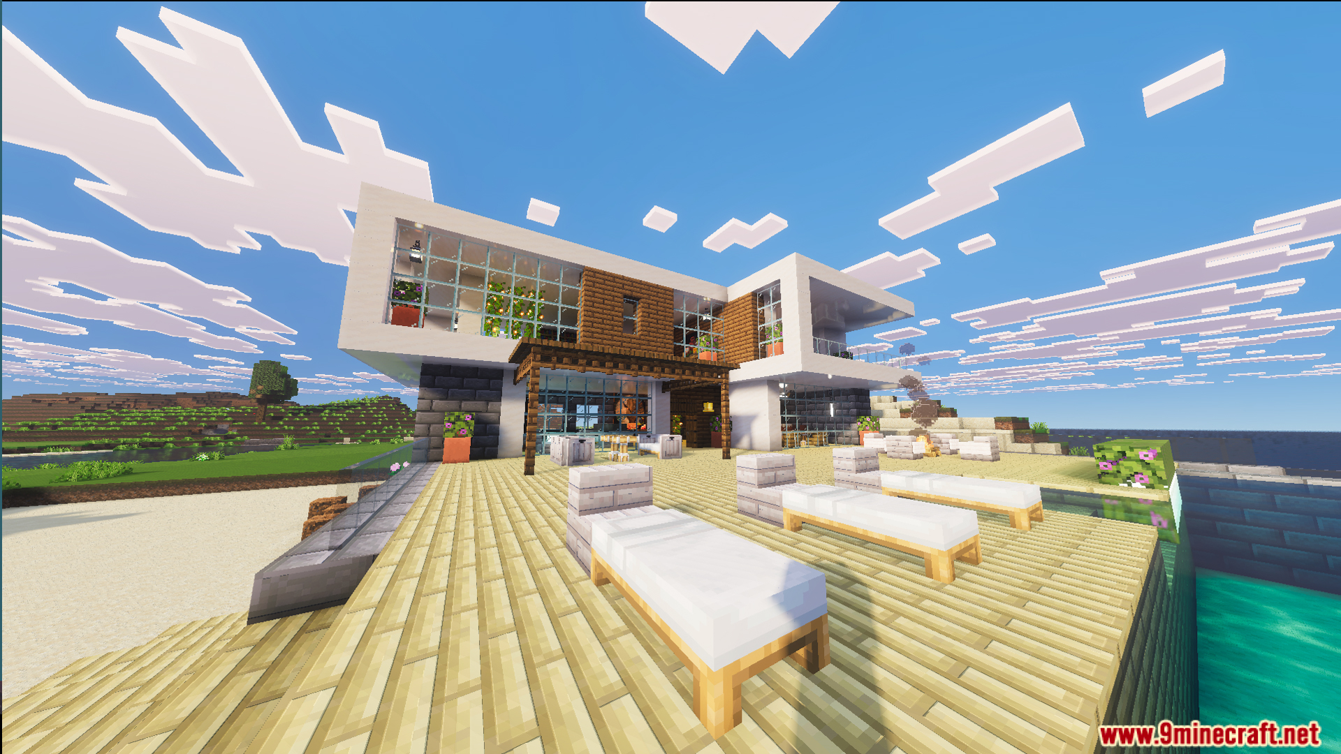 Outdoor patio with sun loungers and a swimming pool overlooking the ocean
