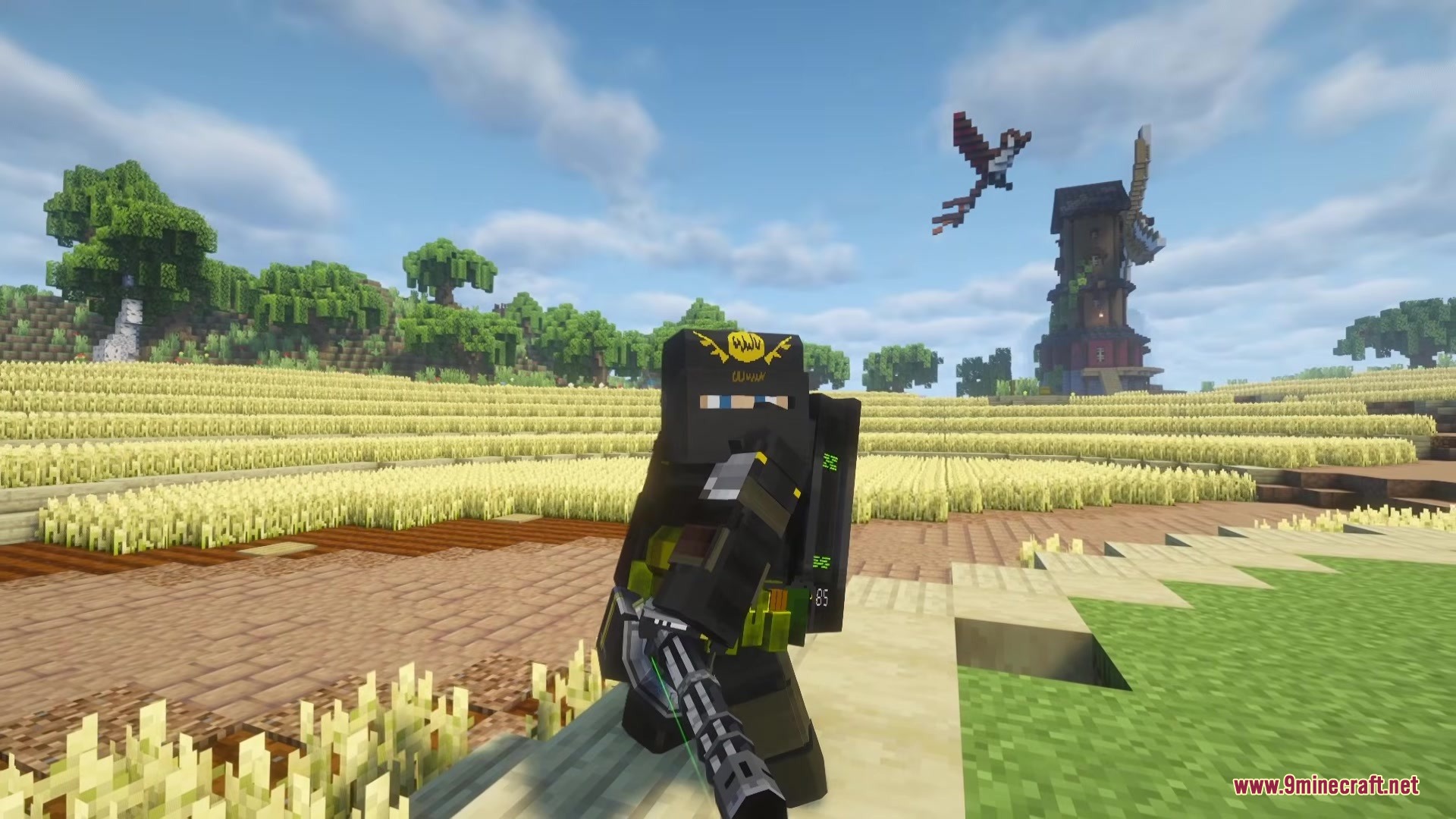 TACZ Juggernaut Armoury Mod Screenshot 1 A player wearing Juggernaut armor holding a minigun in a wheat field