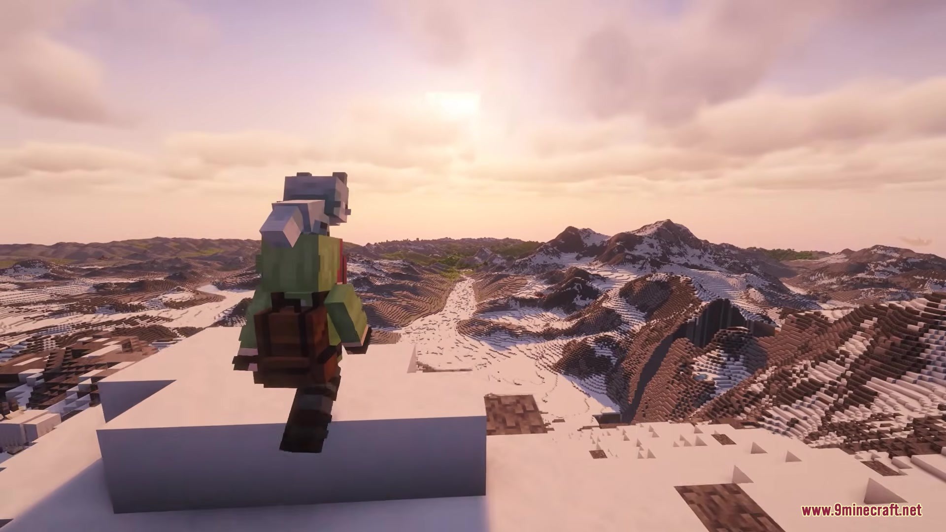 Player character with a backpack overlooking a vast snowy mountain range