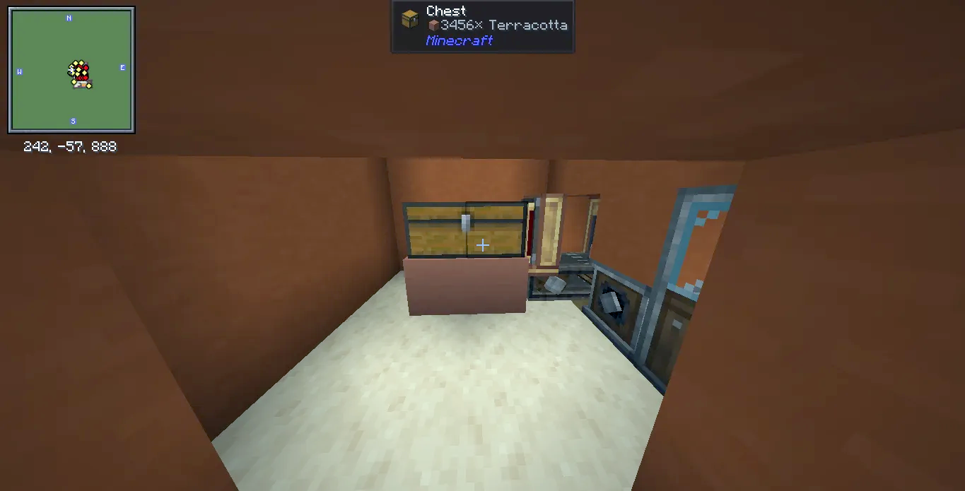 A chest filled with terracotta blocks inside a small orange factory room