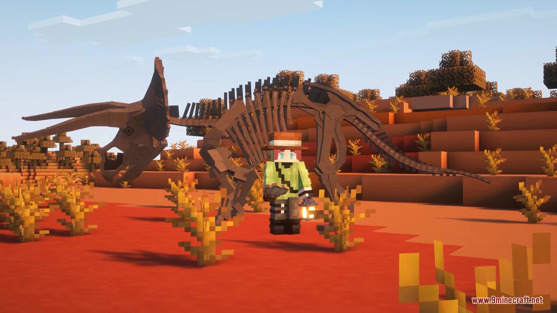 The Fossils Mod Screenshot 11 A Minecraft explorer standing next to a massive dinosaur skeleton in the desert
