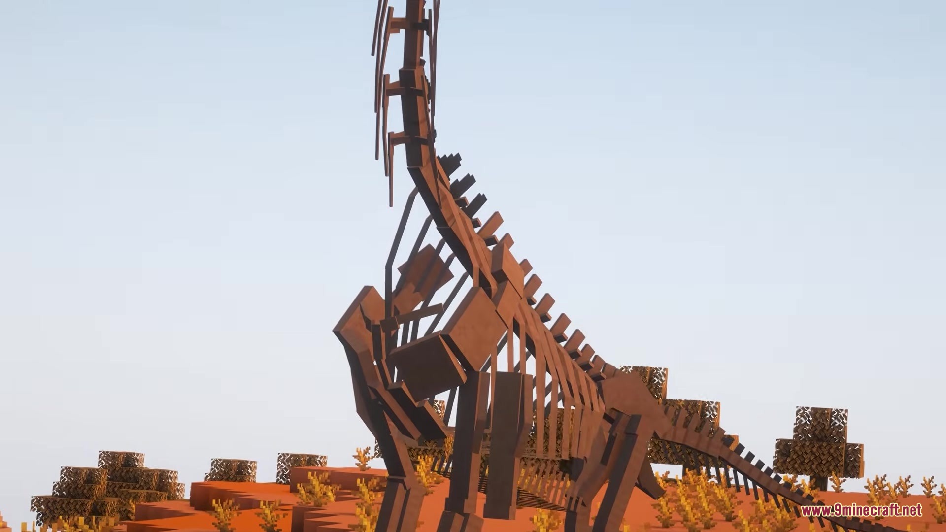 The Fossils Mod Screenshot 9 A massive dinosaur skeleton with iron supports stands in a desert biome