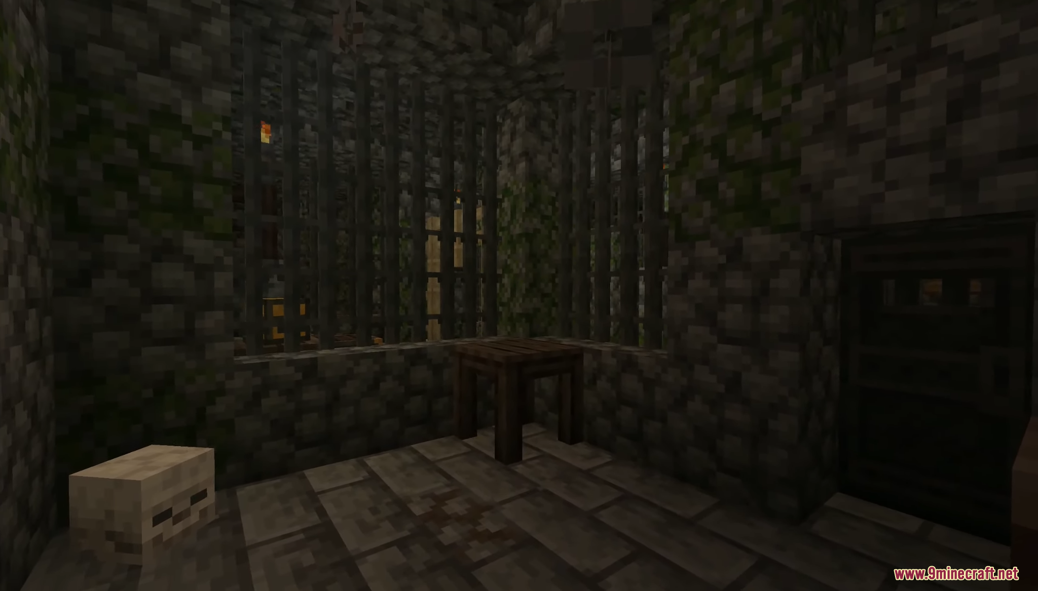 A dark mossy prison cell with iron bars and a skeleton skull