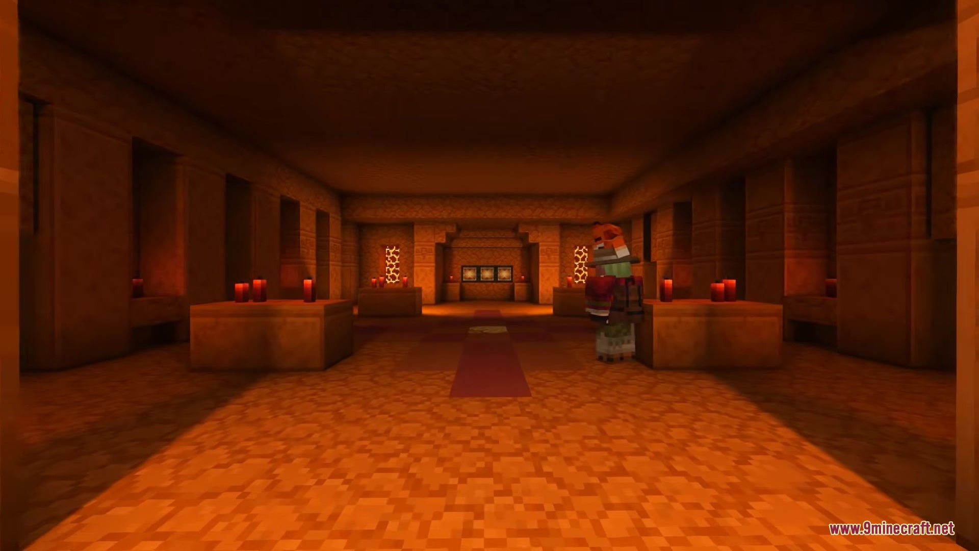 Player wearing unique armor explores a dark sandstone chamber with red candles