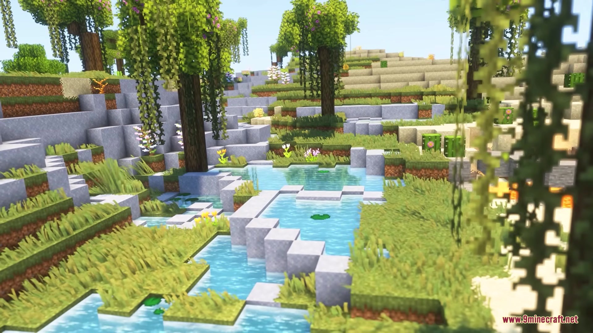 Lush green landscape with hanging vines and small ponds featuring lily pads