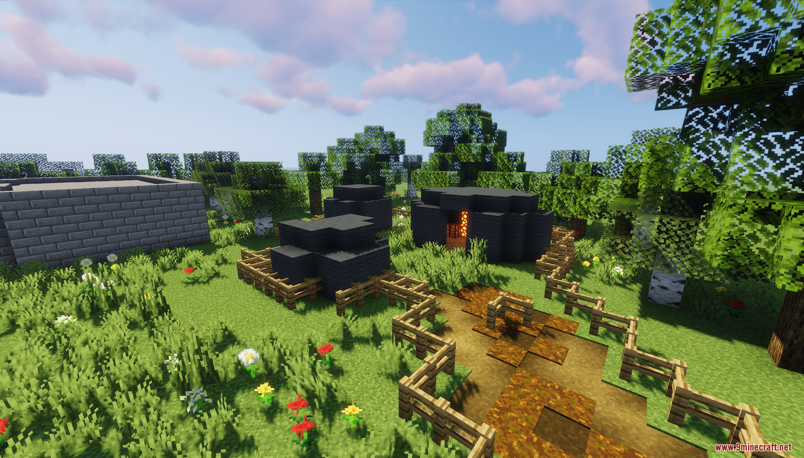 The Town of Mordovia Map Screenshot 7 Small black circular huts and a stone building in a grassy field